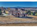 Aerial view of a two story home on a large lot with mountain views at 6937 Brookeview Ct, Parker, CO 80134