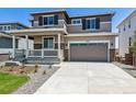 Two-story home with front porch and attached garage at 3302 N Highlands Creek Pkwy, Aurora, CO 80019