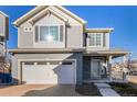 Two-story house with attached garage and landscaped front yard at 237 S Old Hammer St, Aurora, CO 80018