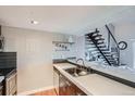 Modern kitchen with stainless steel appliances and a breakfast bar at 10785 W 63Rd Pl # 307, Arvada, CO 80004