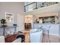 Open living space with a kitchen island, dining area, and loft at 10785 W 63Rd Pl # 307, Arvada, CO 80004