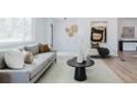 Living room featuring a gray sofa, coffee table, and modern artwork at 4601 S Lipan St, Englewood, CO 80110