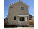 Brick front elevation of a two-story home with a modern design at 6937 Kendick Ln, Arvada, CO 80007