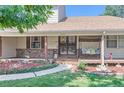Inviting front porch with a porch swing and wrought iron gate at 10021 Miller St, Broomfield, CO 80021