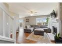 Living area with sectional sofa, fireplace and hardwood floors at 11615 Masonville Dr, Parker, CO 80134