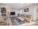 Cozy living room with hardwood floors and comfy seating at 208 Wark Ave, Berthoud, CO 80513