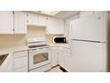 Bright kitchen features white appliances, ample counter space, and plenty of cabinets at 1915 S Balsam St, Lakewood, CO 80227