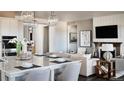 Open kitchen with island and adjacent living space at 16975 Black Rose Cir, Parker, CO 80134