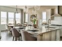 Gourmet kitchen with large island, modern appliances, and plenty of natural light at 16975 Black Rose Cir, Parker, CO 80134