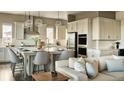 Modern kitchen with white cabinets, quartz countertops and stainless steel appliances at 16975 Black Rose Cir, Parker, CO 80134