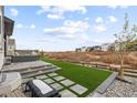 Landscaped backyard with artificial turf and patio area at 6726 Crossbridge Cir, Castle Rock, CO 80108