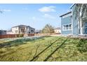 Large backyard with grassy area, partially covered in snow at 12956 E 107Th Pl, Commerce City, CO 80022