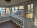 Bright sun porch with tiled floor and view of the street at 841 N Bross St, Longmont, CO 80501