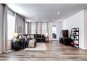 Spacious living room featuring a sectional sofa and large windows at 9657 Bennett Peak St, Littleton, CO 80125