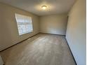 Simple bedroom with carpet flooring and a window with blinds at 2084 S Rifle St, Aurora, CO 80013