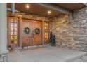Elegant entryway with double doors and stonework at 12963 Silver Elk Ln, Littleton, CO 80127