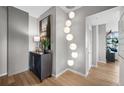 Bright entryway with hardwood floors, modern light fixture, and stylish console table at 1700 Bassett St # 1901, Denver, CO 80202
