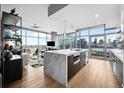 Modern kitchen with marble island, stainless steel appliances, and city views at 1700 Bassett St # 1901, Denver, CO 80202