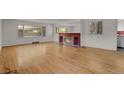 Spacious living room featuring hardwood floors and a brick fireplace at 577 96Th St, Louisville, CO 80027