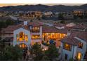 Night view of a grand home with a large patio, nestled in a mountain community at 7944 Dante Dr, Littleton, CO 80125