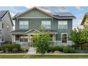 Two-story house with solar panels and landscaping at 9385 E Prairie Meadow Dr, Denver, CO 80238