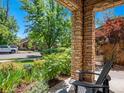 Inviting front porch with stone pillars, landscaping, and a view of the neighborhood at 2741 Java Ct, Denver, CO 80211