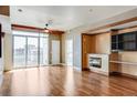 Hardwood floor living room, fireplace, and city views at 2001 Lincoln St # 1024, Denver, CO 80202