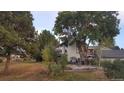 Home's backyard features a patio with seating area, surrounded by lush landscaping and trees at 6803 S Liverpool St, Centennial, CO 80016