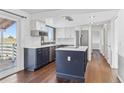 Modern kitchen with stainless steel appliances, an island, and hardwood floors at 18365 E Mansfield Ave, Aurora, CO 80013