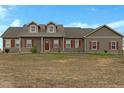 House exterior featuring a two-story home with red shutters and a large yard at 56 W 8Th Ave, Byers, CO 80103