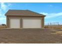 Three car garage with white doors at 56 W 8Th Ave, Byers, CO 80103