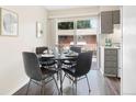 Small dining area with a black table and four chairs, near the kitchen at 850 Utica St # B, Denver, CO 80204