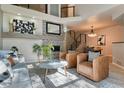 Bright living room with vaulted ceilings, fireplace, and hardwood floors at 8016 E Fairmount Dr, Denver, CO 80230