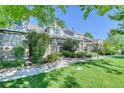 Two-story townhome with walkway and landscaping at 8016 E Fairmount Dr, Denver, CO 80230