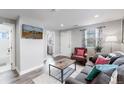 Living room with a view of the bathroom and entryway at 3040 W 66Th Ave, Denver, CO 80221