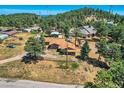 Aerial view of a home on a wooded lot, mountain views at 801 Panorama Dr, Golden, CO 80401