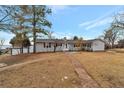 Ranch-style home with mature trees and a landscaped yard at 11960 Quebec St, Brighton, CO 80602