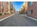 Residential building with parking and a paved road at 301 Inverness Way # 209, Englewood, CO 80112