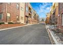 Residential building with parking and a paved road at 301 Inverness Way # 209, Englewood, CO 80112