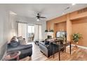 Living room with leather couches, a fireplace, and hardwood floors at 301 Inverness Way # 209, Englewood, CO 80112