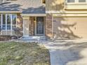 House exterior boasts a brick facade, attached garage, and well-manicured lawn at 7591 S Xanthia Ct, Centennial, CO 80112