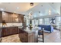 Modern kitchen with dark cabinets, island, and stainless steel appliances at 475 W 12Th Ave # 7G, Denver, CO 80204