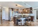 Modern kitchen with dark wood cabinets and an island with seating at 475 W 12Th Ave # 7G, Denver, CO 80204