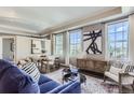 Living room with large windows, stylish furniture, and city view at 475 W 12Th Ave # 7G, Denver, CO 80204