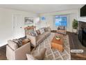 Virtually staged living room featuring neutral tones and fireplace at 4635 Sable St, Denver, CO 80239