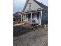 Two-story house with front porch and landscaping at 305 Strong St, Brighton, CO 80601