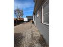 Gravel driveway and backyard with shed at 305 Strong St, Brighton, CO 80601