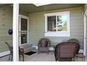 Cozy covered patio with wicker furniture, perfect for relaxing at 4062 S Rifle Way, Aurora, CO 80013