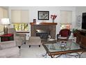 Living room with fireplace, large windows, and comfortable seating at 4062 S Rifle Way, Aurora, CO 80013