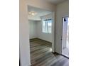 Bright entryway with vinyl plank flooring and view to backyard at 2900 Nectar St, Strasburg, CO 80136